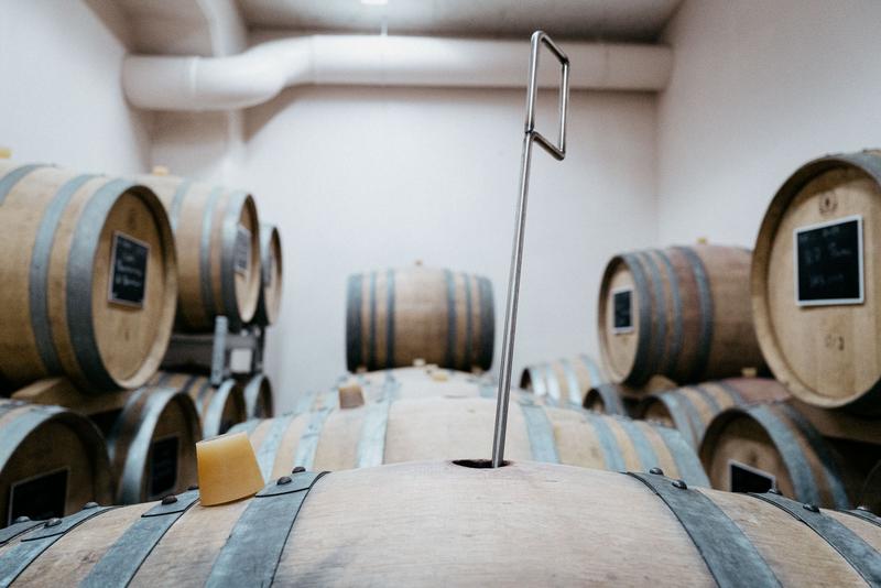Batonnage stick left in barrel inside barrel room at Domaine Alexandre Bonnet