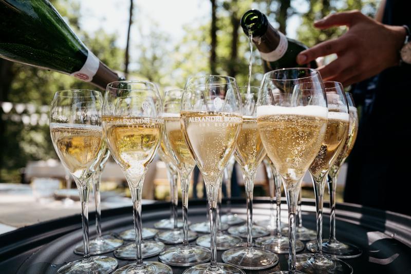 Tray of glasses of Alexandre Bonnet champagne being filled by two waiters