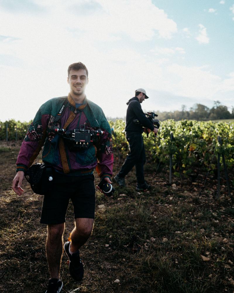 Behind the scenes of Jérome Grémy walking towards camera amongst vines of Les Riceys