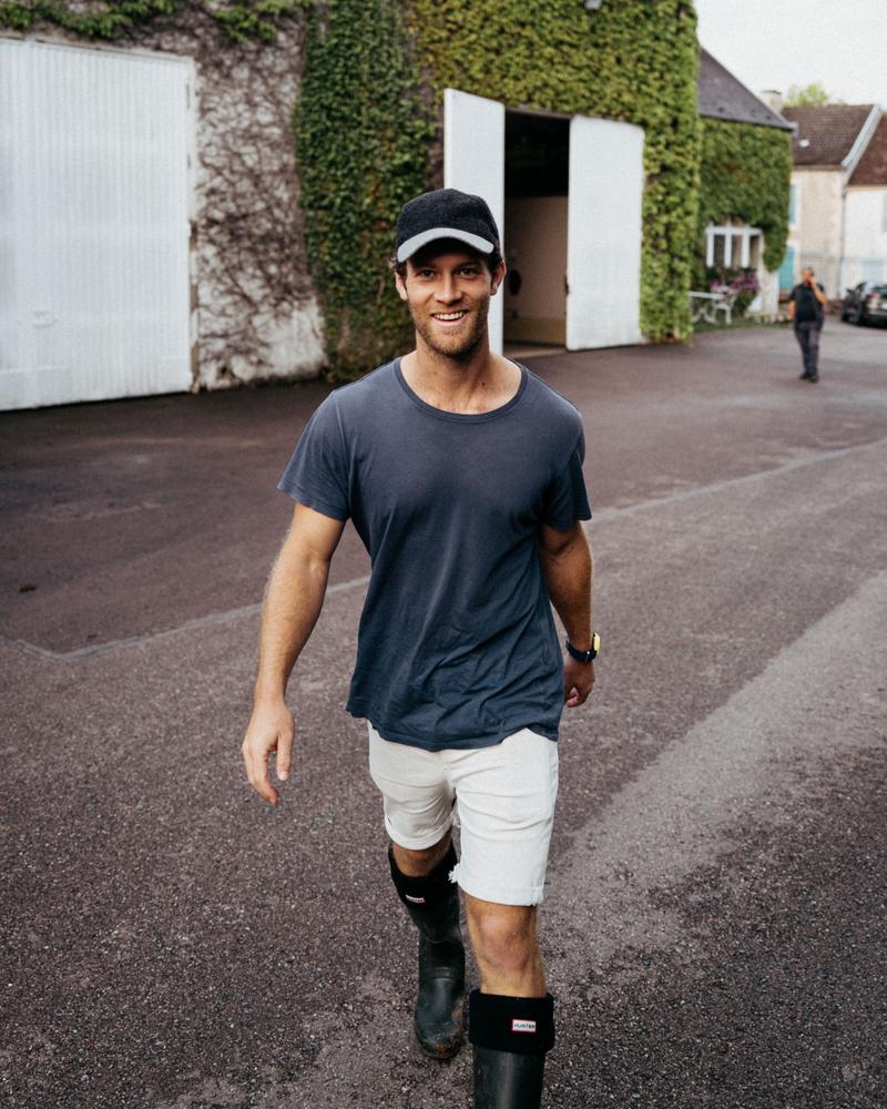 Director Edward Taylor walking towards camera smiling at Alexandre Bonnet