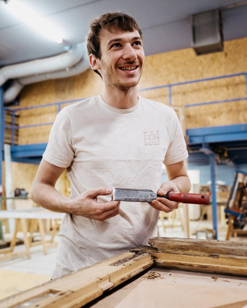 Portrait of smiling apprentice at Metiers du Bois Paris