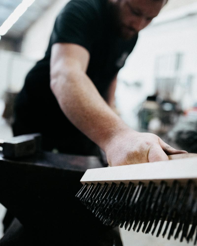 Metal worker using iron brush