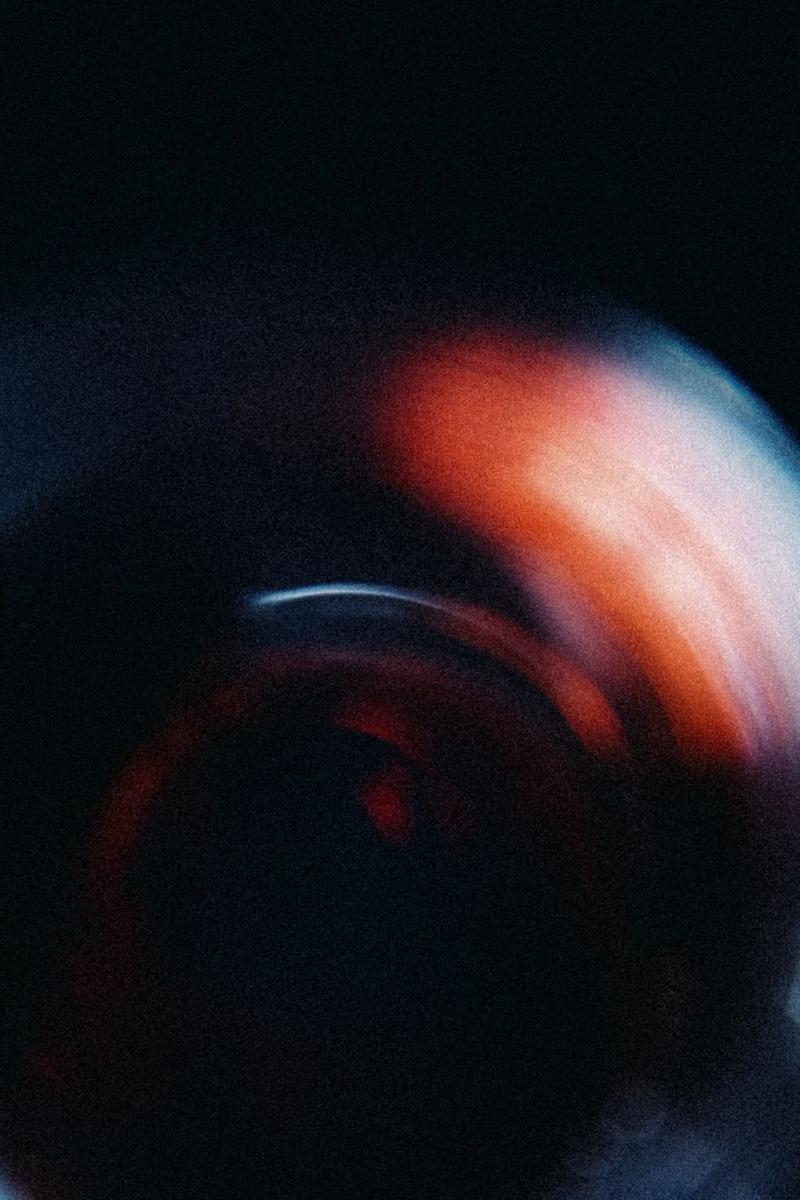 Artistic long exposure of red wine swirling inside wine glass