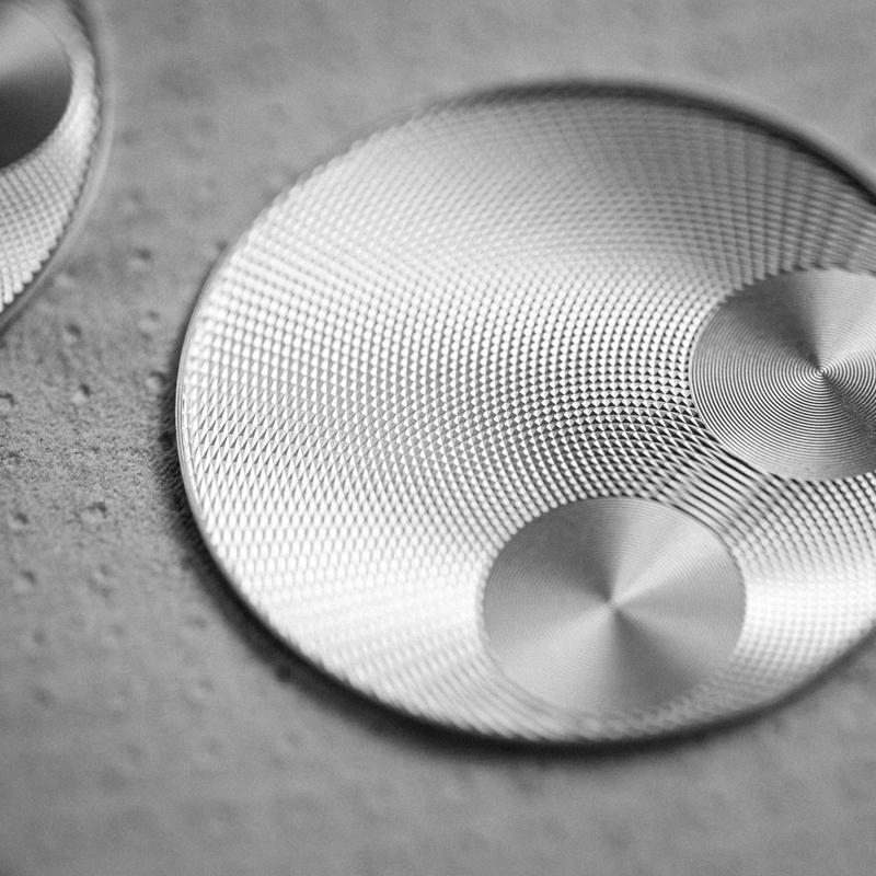 Macro of patterened ornamental guilloche engraving on watch faces