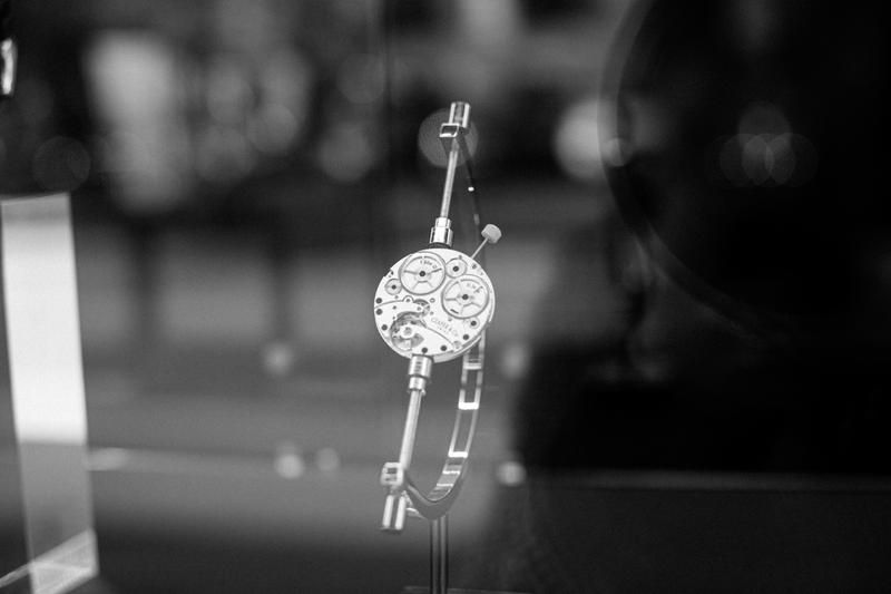 View through window of Czapek watch mechanism held in vice
