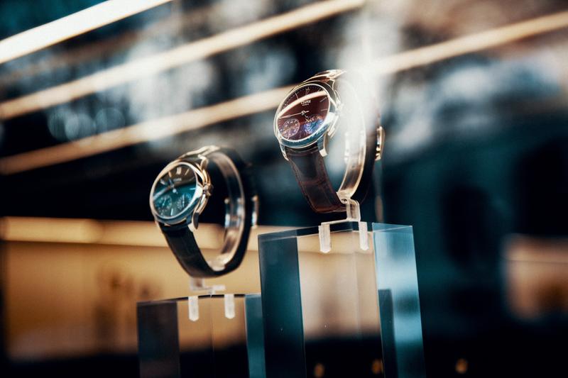 View through Czapek boutique window in Geneva of red and green watches