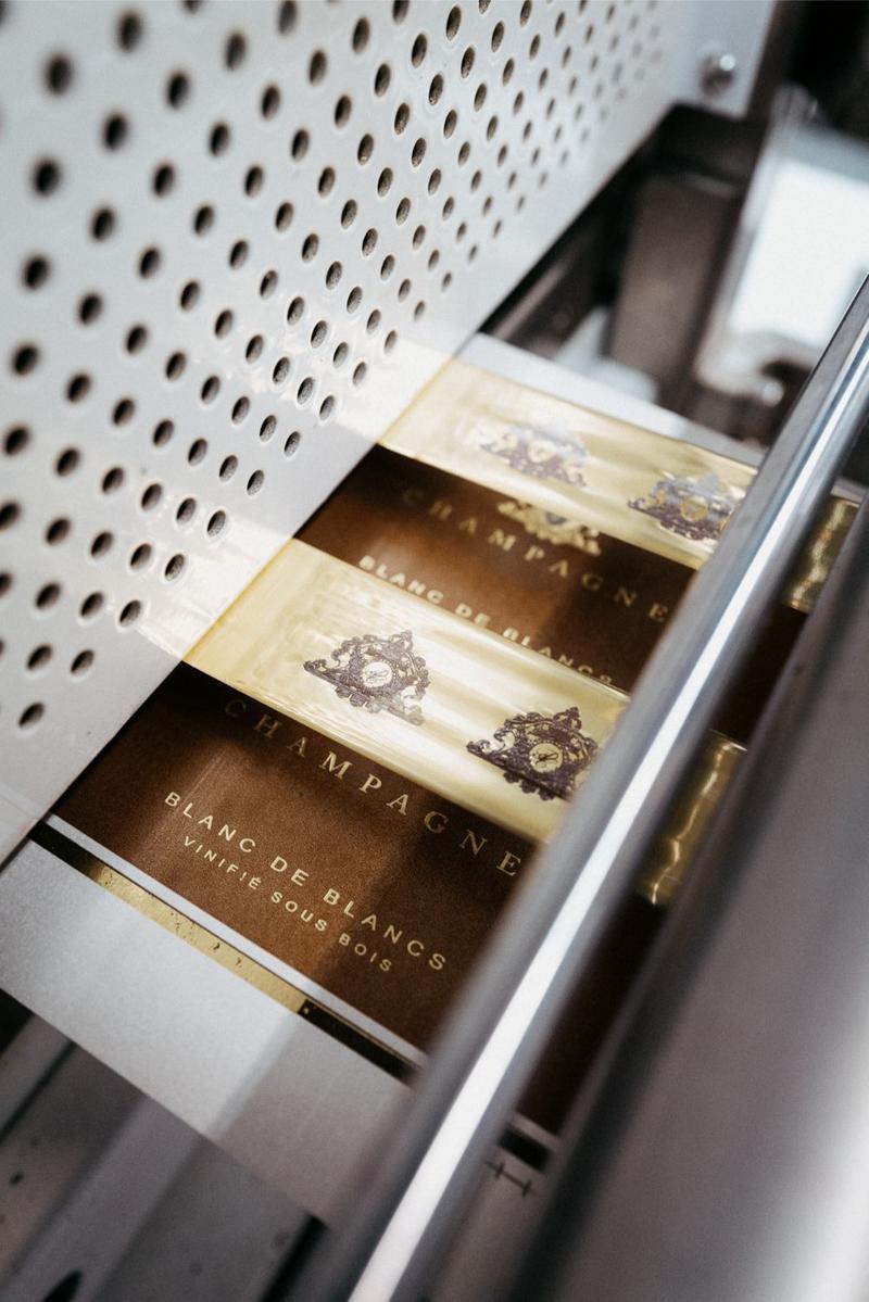 Champagne De lozey blason foiling being applied to labels