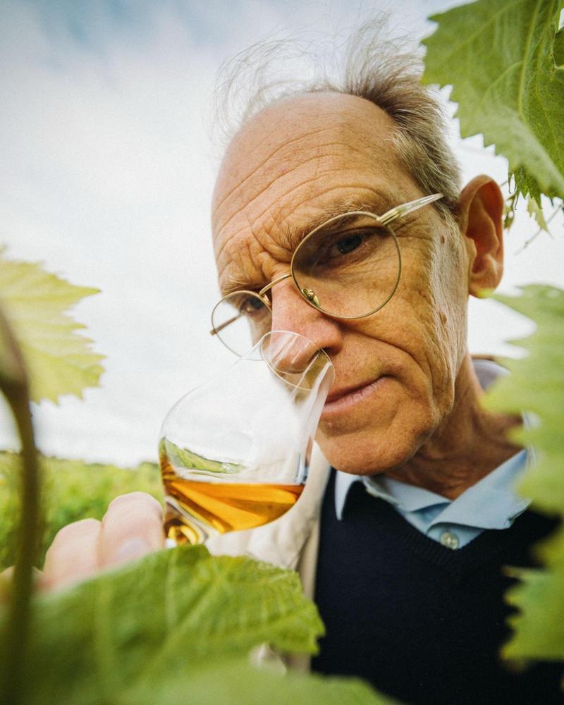 Delamain Cellar Master Charles Braastad smelling Cognac between rows of vines