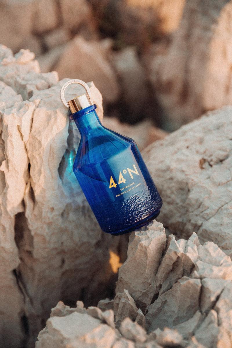 Bottle of Gin 44 lying between two rocks on the Cote Azur