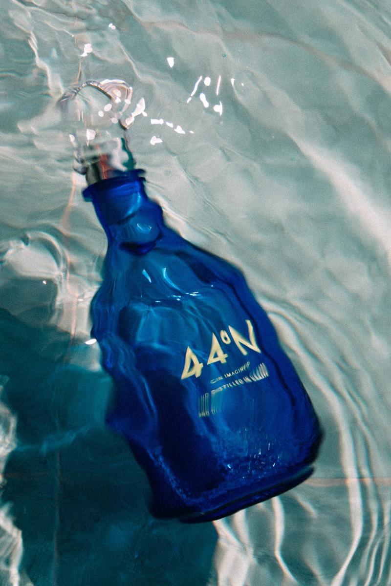 Bottle of Gin 44 under water in a swimming pool