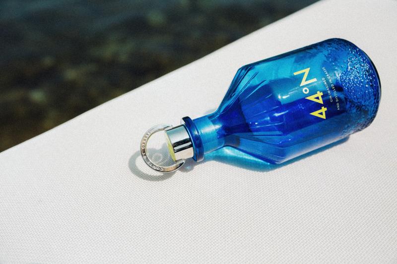 Bottle of Gin 44 lying on white sun-lounger