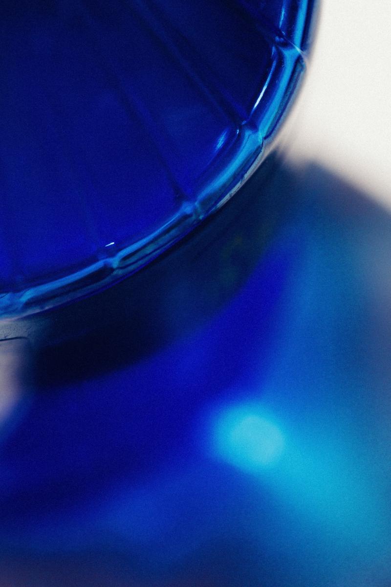 Macro of blue light projections through bottle of Gin 44