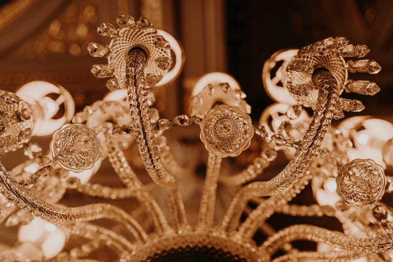 View from below onto chandelier in golden light