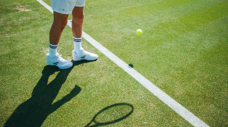 Still from Lanson x Wimbledon campaign, bouncing ball before serve