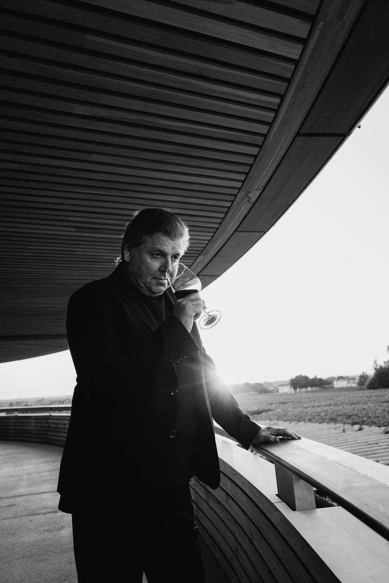 Portrait of Jonathan Maltus tasting wine at sunset