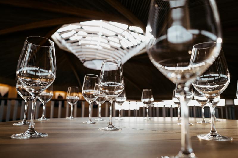 Empty glasses on circular table inside Le Dôme winery