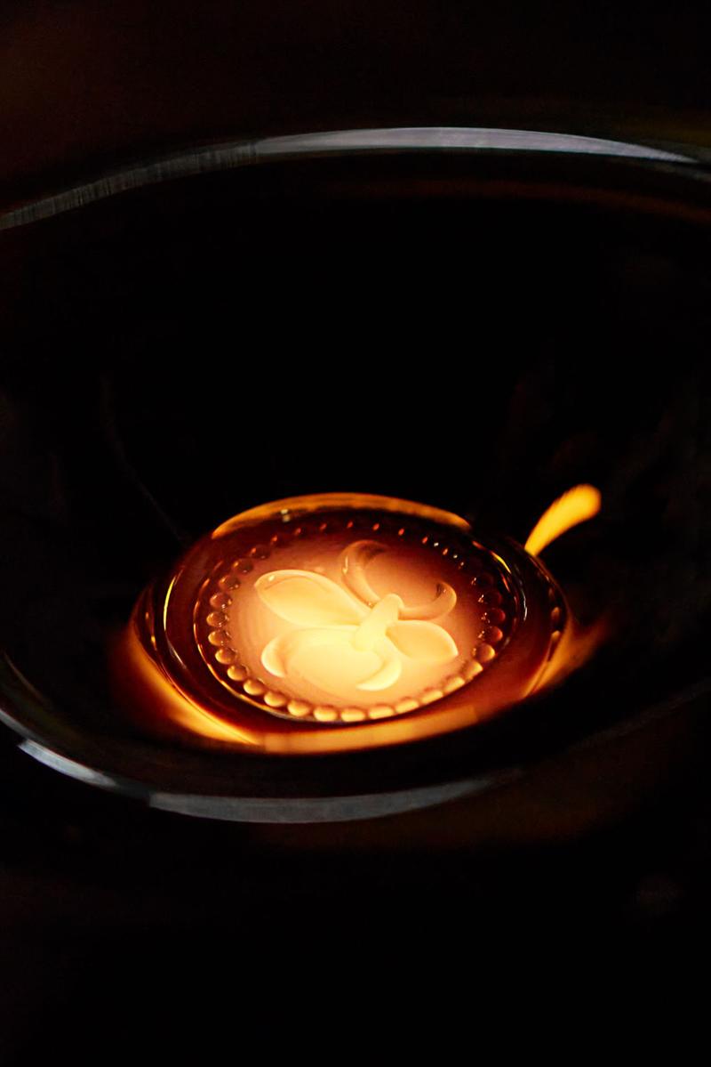 Close-up of fleur de lys on louis xiii rare cask during glass sculpting