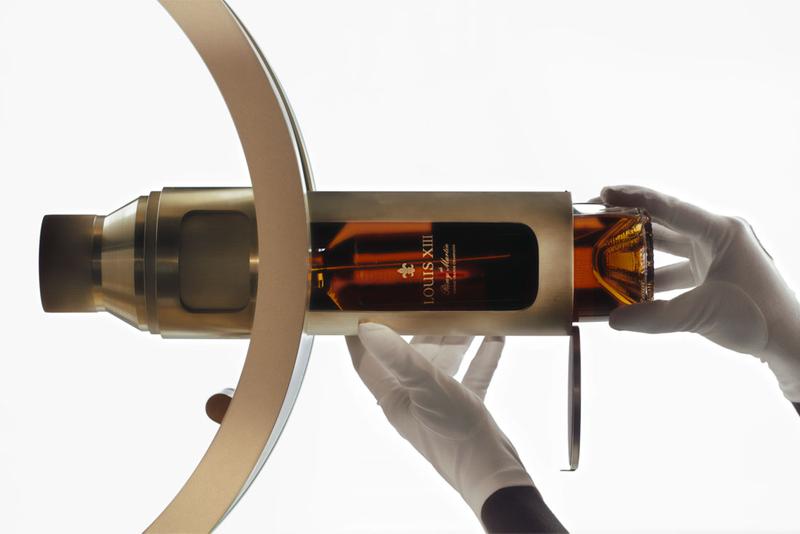 Hand inserting capsule into Louis XIII infinity wheel