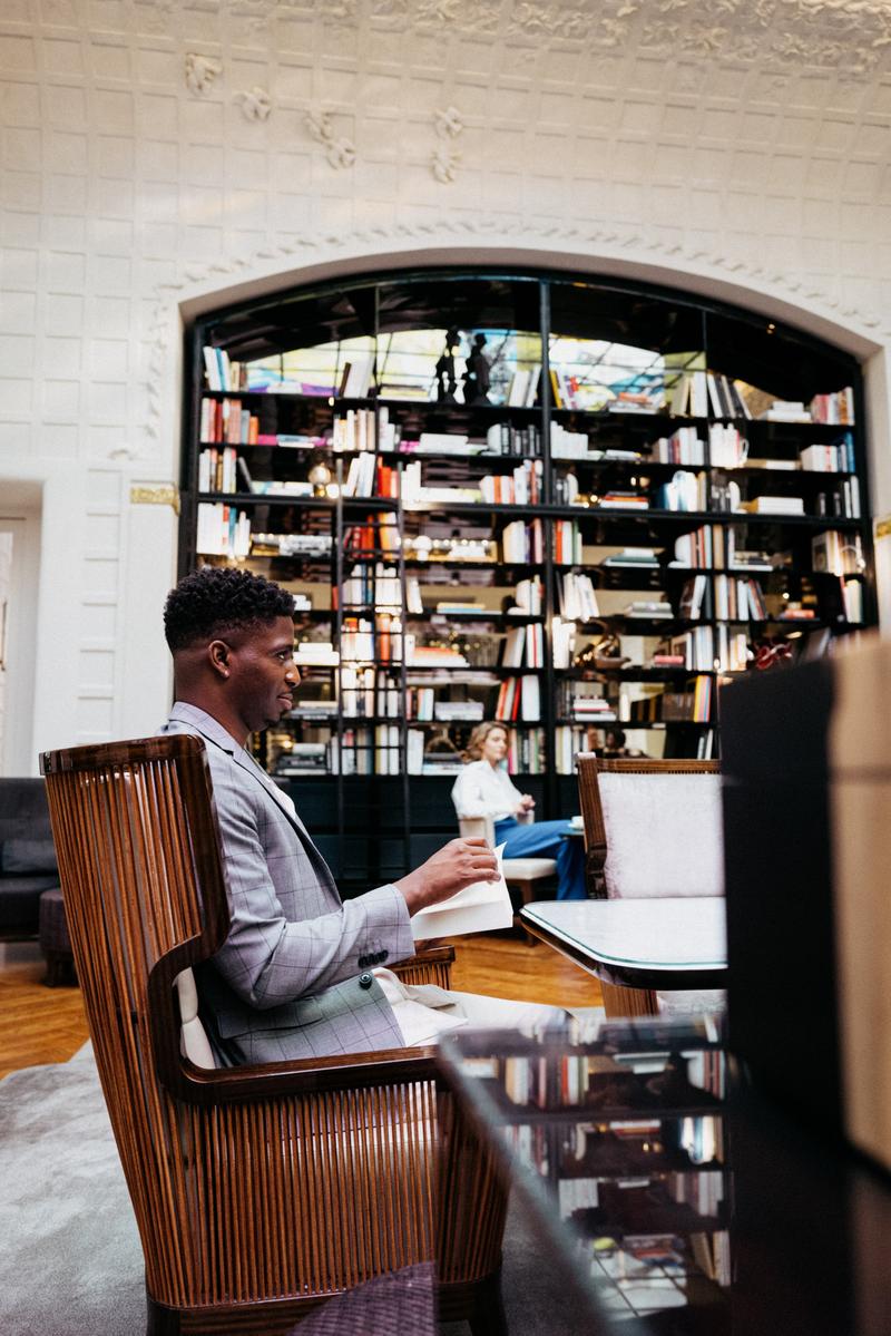 Backstage of Samuel Arnold reading a book in the salon Saint-Germain, Hotel Lutetia