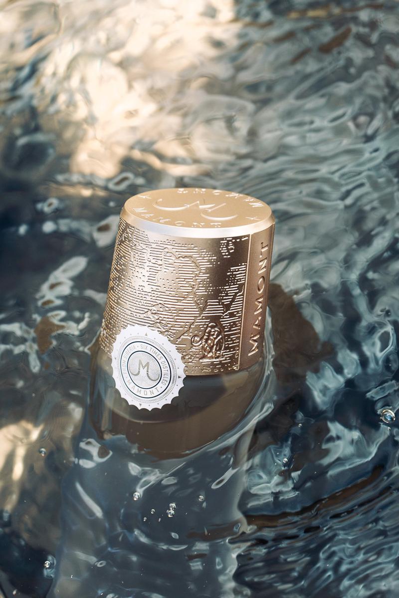 Macro of Mamont vodka capsule surrounded by flowing water