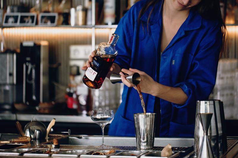 Juliette Larrouy pouring a measure of Martell VSOP into a cocktail shaker