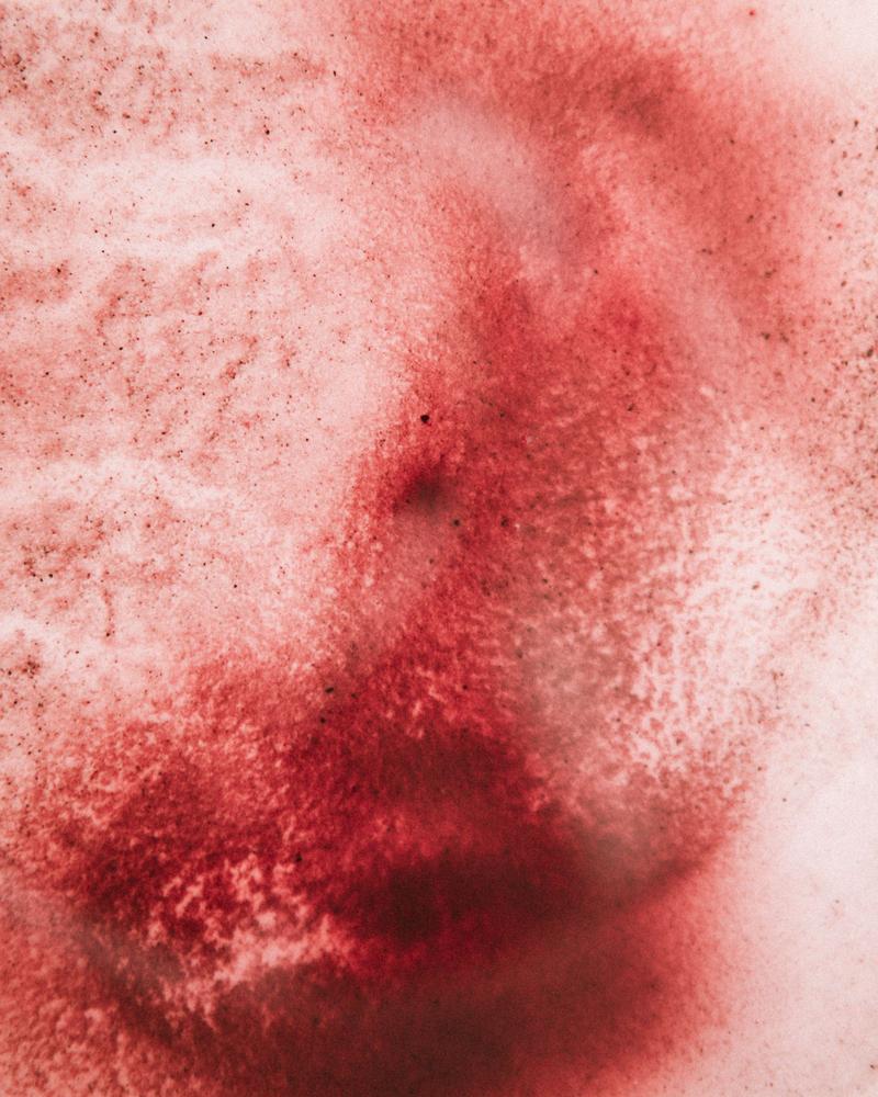 Macro of wine residue in white plastic bucket