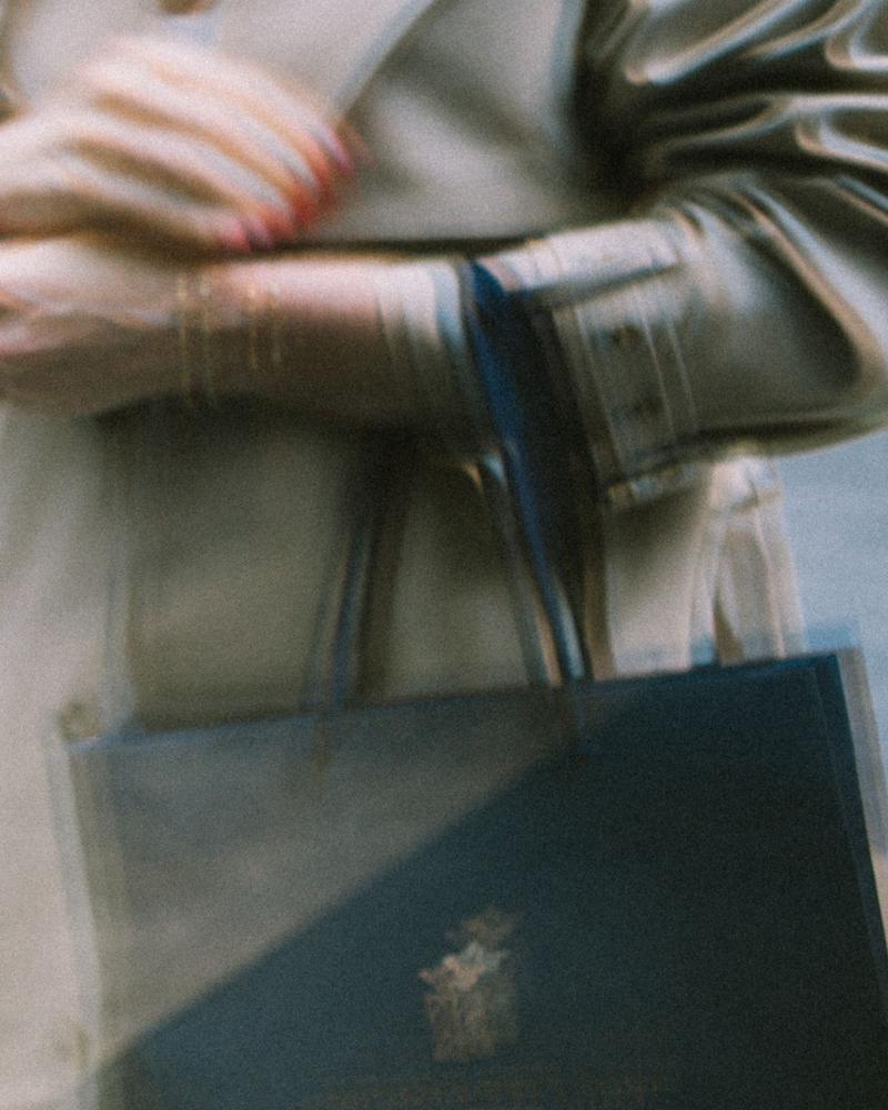 View through window of female holding Chateau Pichon Comtesse gift bag