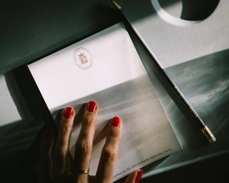 Chateau Pichon Comtesse notebook with pencil and hand on aeroplane fold out tray