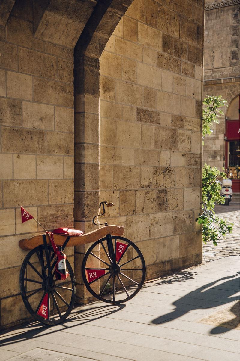 Ronan's vintage push bike leant against Porte Cailhau in Bordeaux