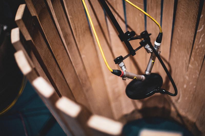 Microphones on stand in the middle of unfinished barrel